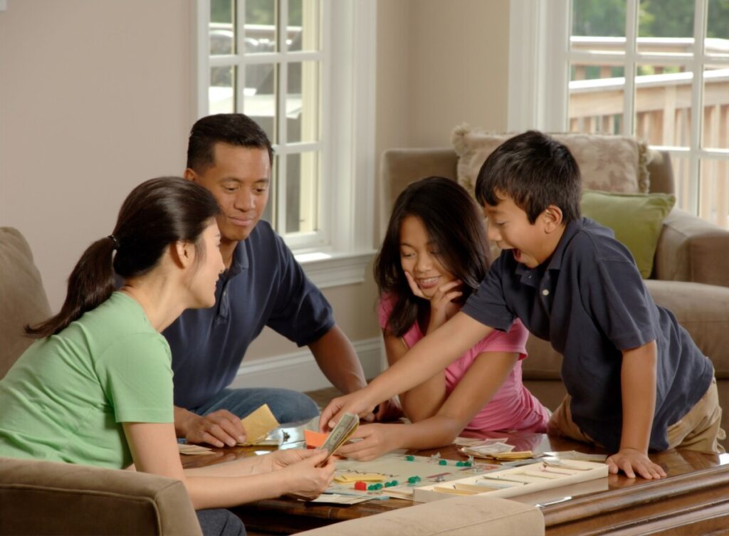 a family playing monopoly
